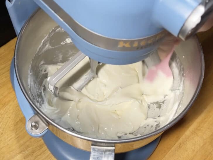 photo of scraping down side of bowl of royal icing for royal icing recipe with meringue powder