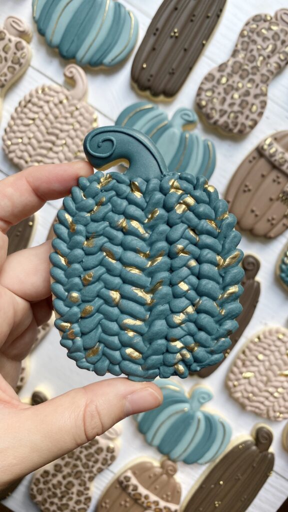pumpkin cookie decorated with royal icing 