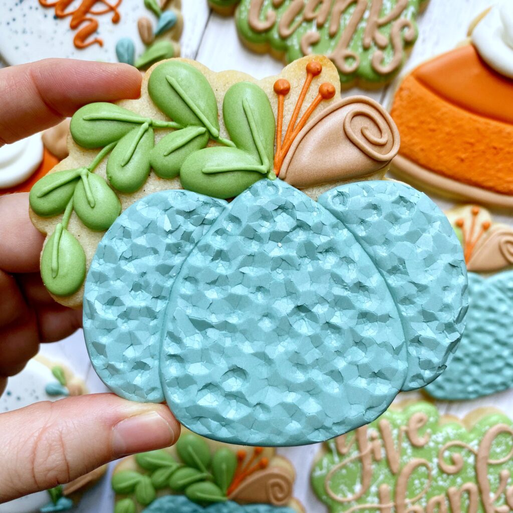 pumpkin cookie decorated with royal icing 