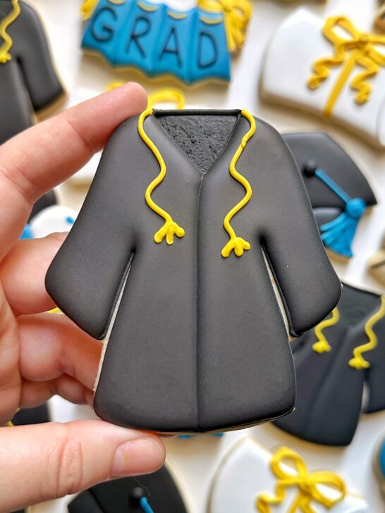 graduation gown cookie decorated with black royal icing