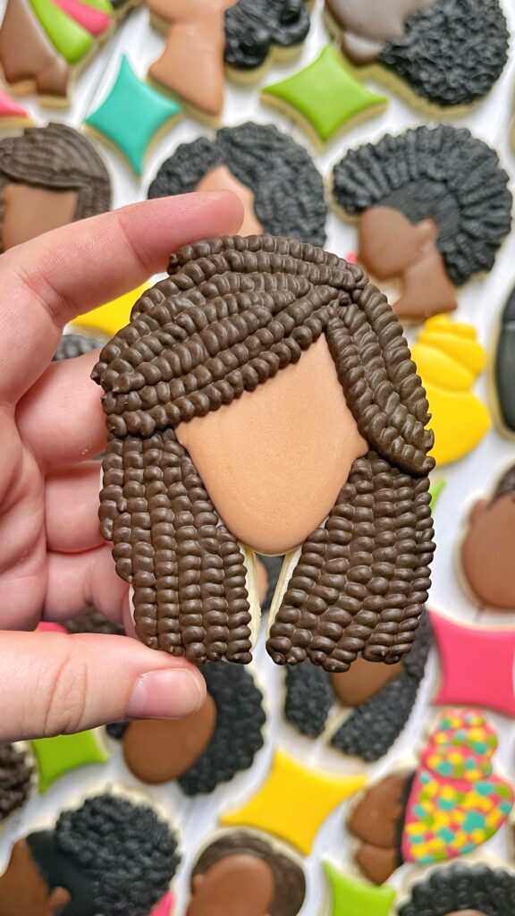 locs hair cookie decorated with royal icing 