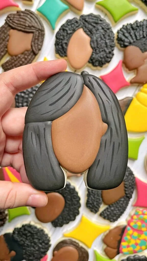 face cookie decorated with royal icing 