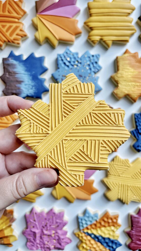maple leaf cookie decorated with royal icing 