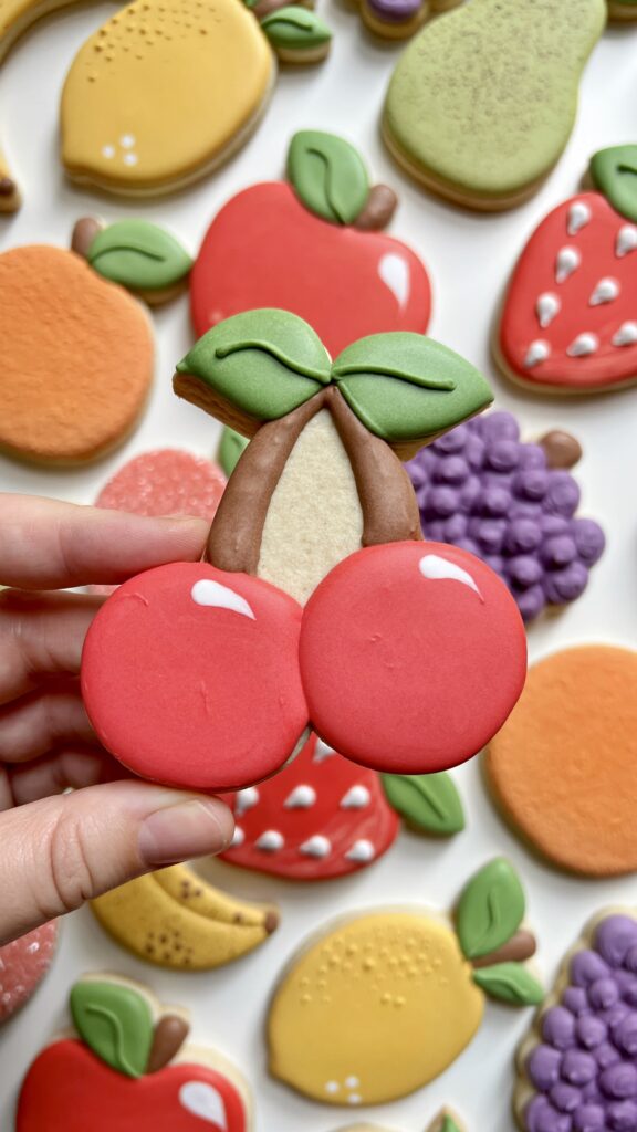 cherry cookie decorated with royal icing 