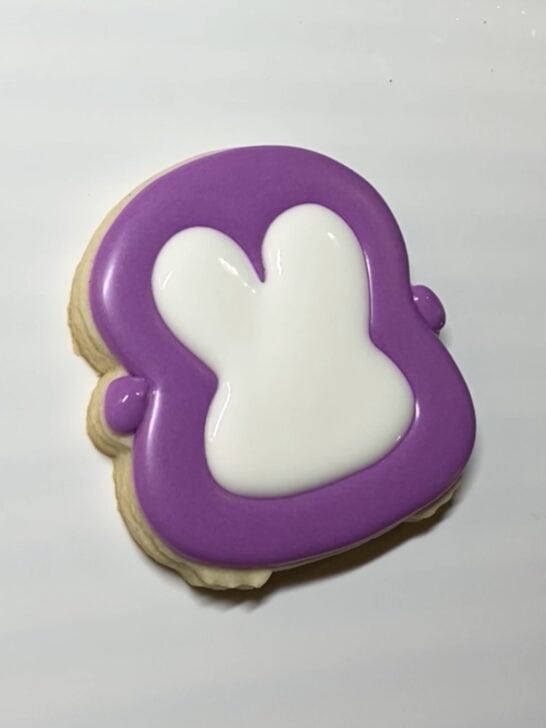 decorating penguin cookies with royal icing