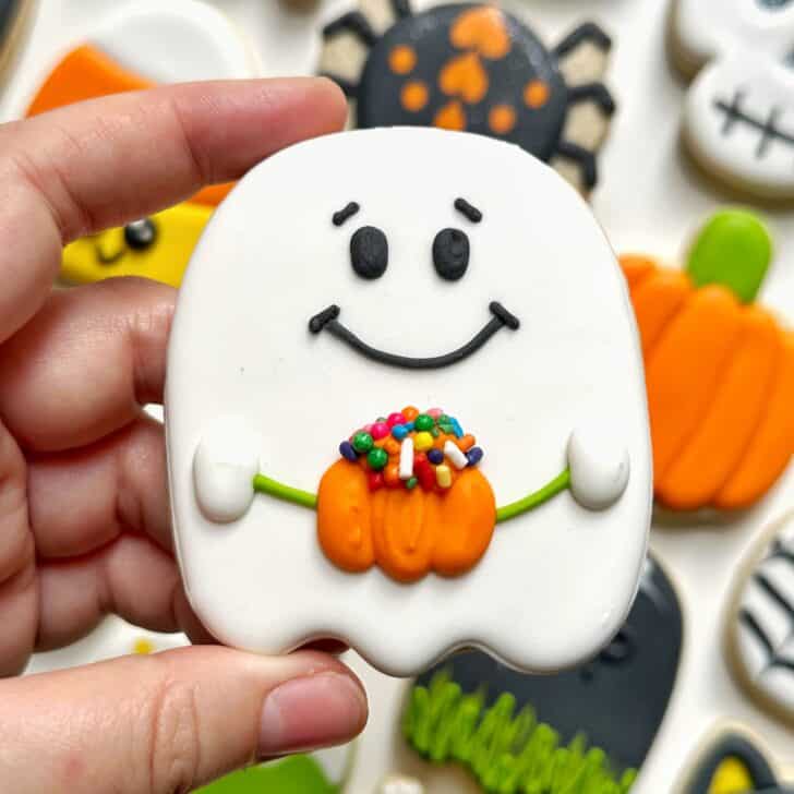 photo of ghost halloween cookie decorated with royal icing