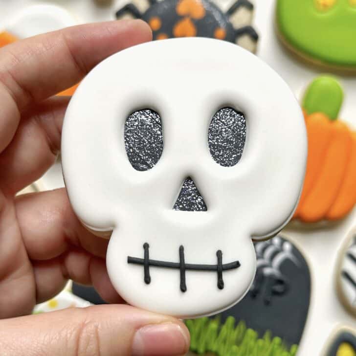 photo of skull halloween cookie decorated with royal icing
