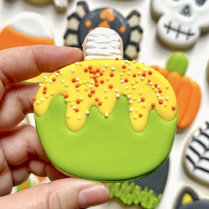 photo of poison apple halloween cookie decorated with royal icing