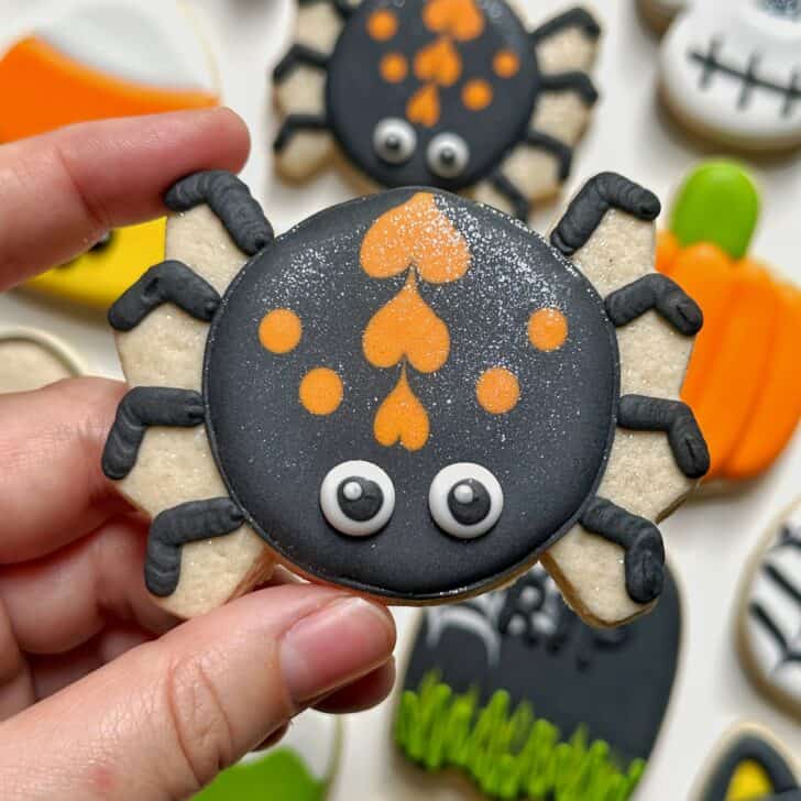 photo of spider halloween cookie decorated with royal icing