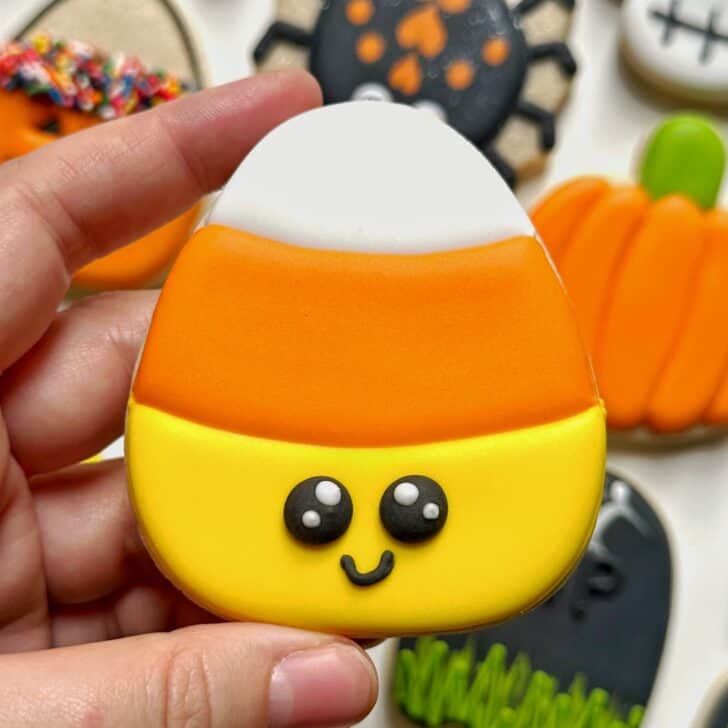 photo of candy corn halloween cookie decorated with royal icing
