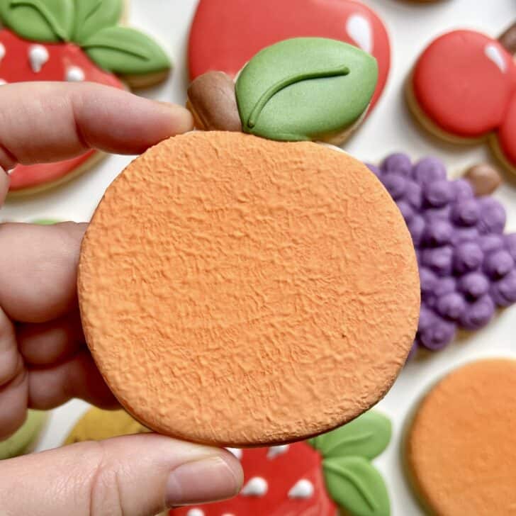 orange cookies decorated with royal icing