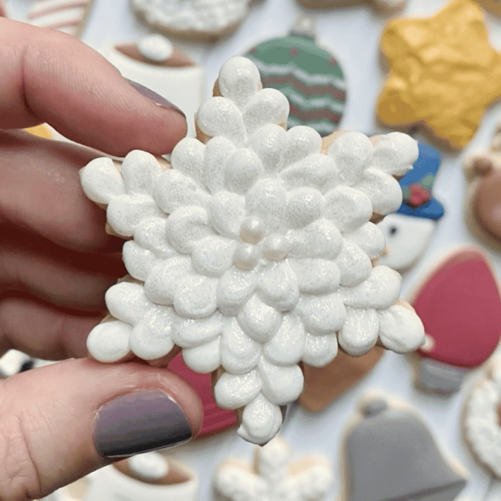 snowflake cookie decorated with royal icing