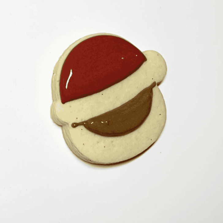 step 2 for decorating a santa cookie with royal icing