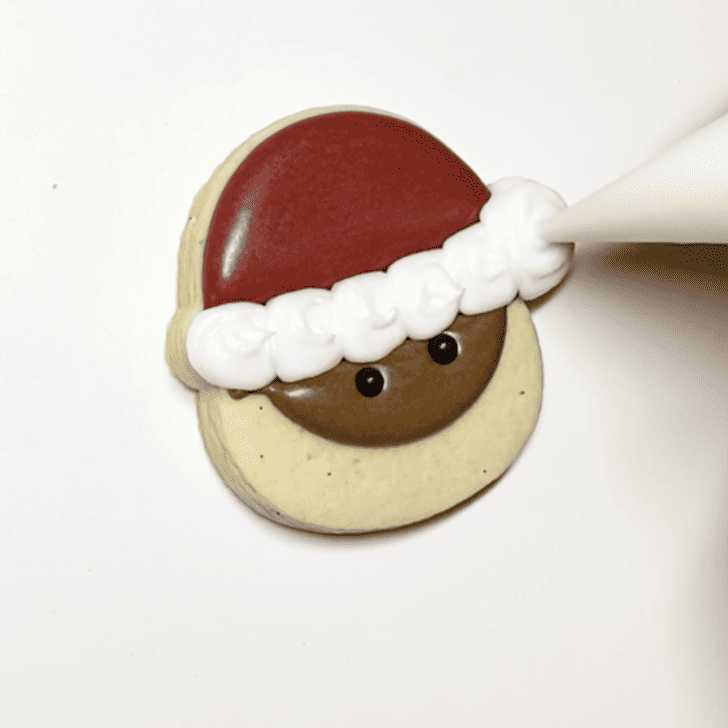 step 4 for decorating a santa cookie with royal icing
