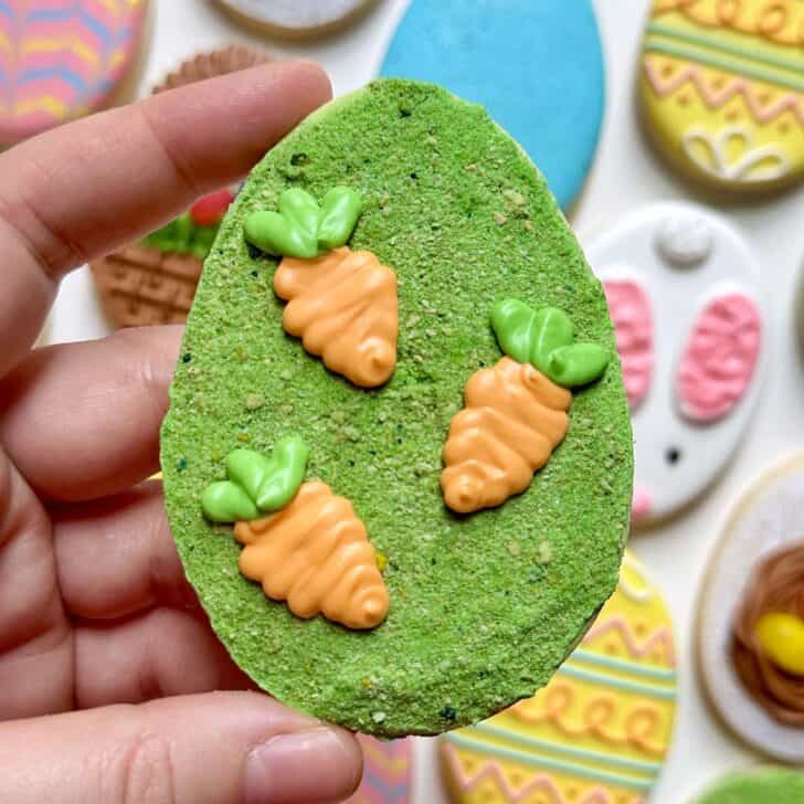 edible moss on a sugar cookie decorated with carrots 