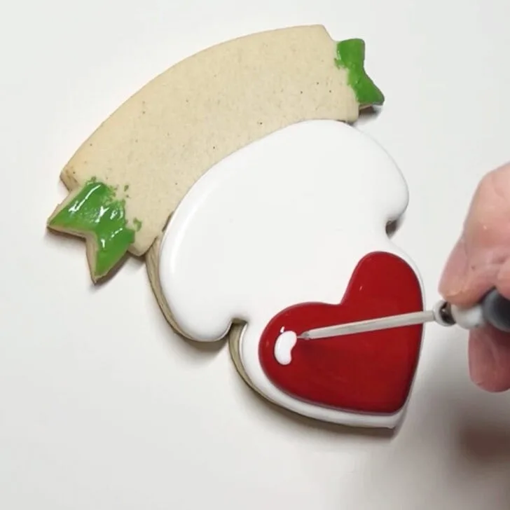 how to decorate teaching is a work of heart cookies with royal icing
