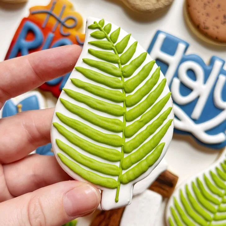 palm leaf cookies decorated with royal icing