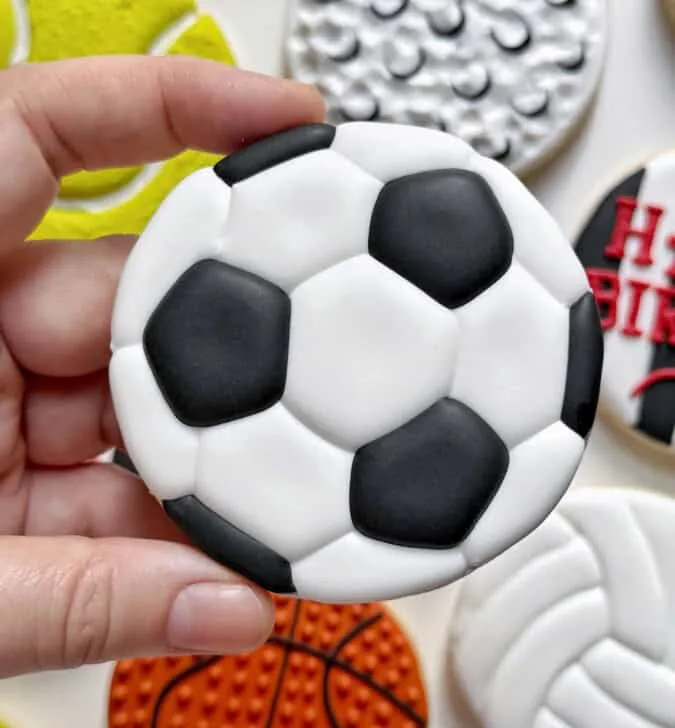soccer ball cookies decorated with royal icing