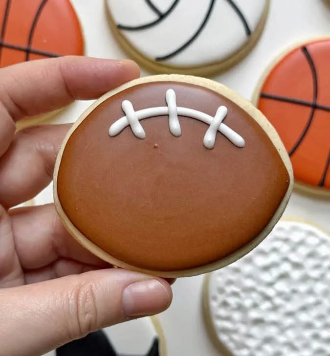 football cookie decorated with royal icing
