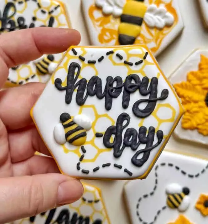 happy bee day cookies decorated with royal icing