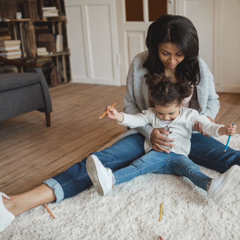 mom and child playing on floor