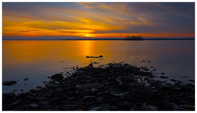 Sun setting over an island on Cayuga Lake.