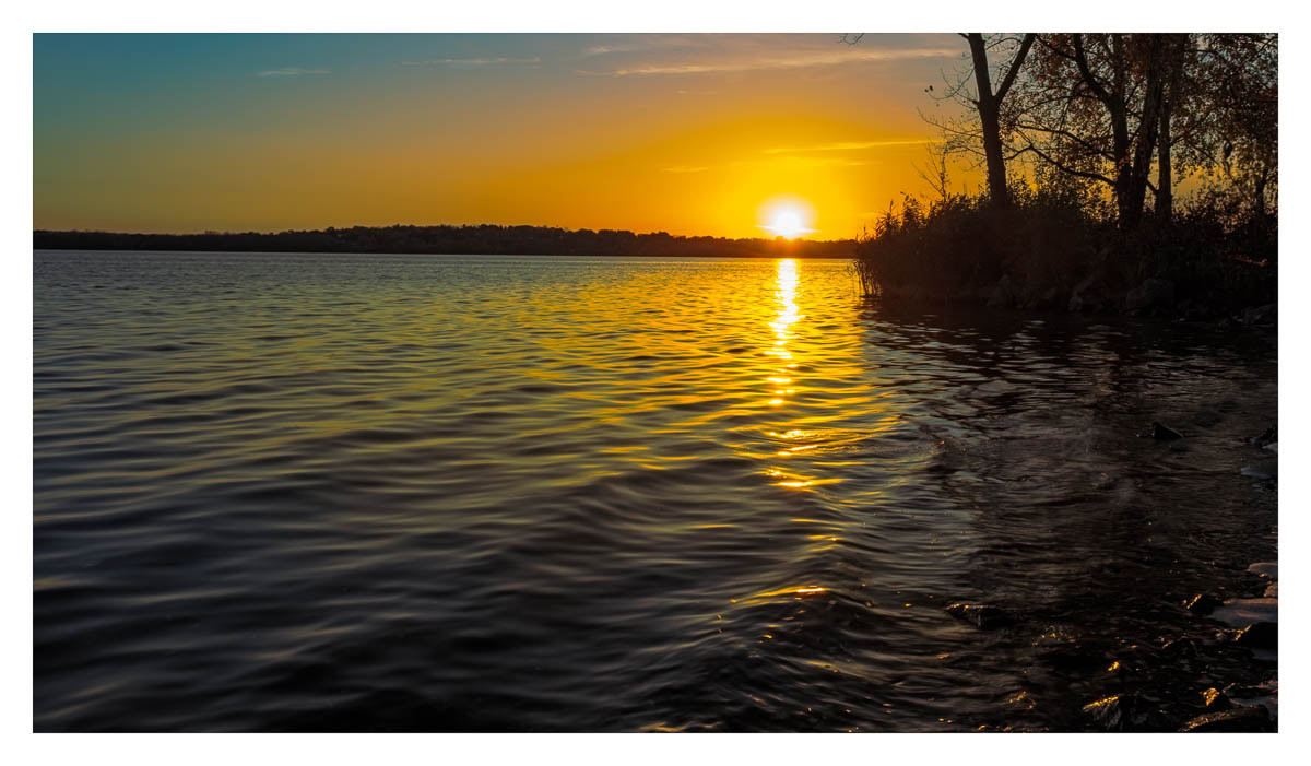 Sun touching the shore of Onondaga Lake.