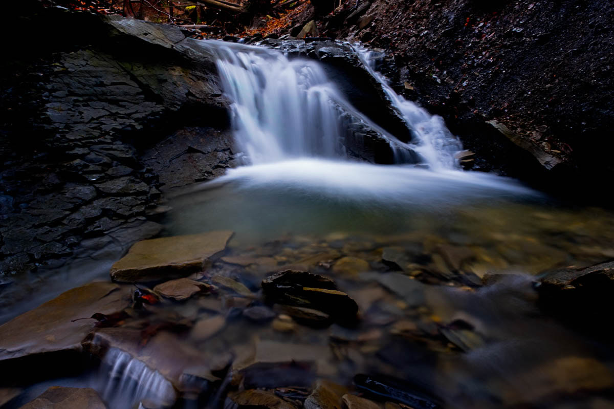 It was getting near dark when I took this image of a small waterfall flowing over a dark black shale outcrop in a narrow ravine. I like how the water lit up the area.