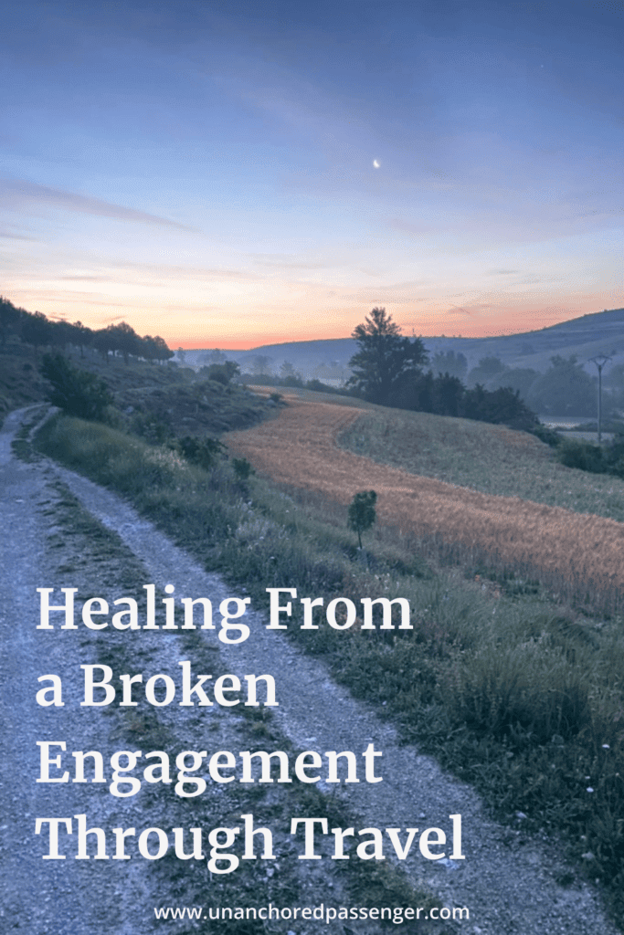 Sunrise over a path in the mountains with text that reads "Healing From a Broken Engagement Through Travel" and "www.unanchoredpassenger.com"