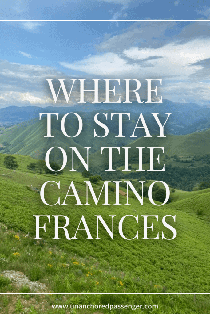 Views of the Pyrenees Mountains below on a sunny day with text that says, "Where to Stay on the Camino Frances"
