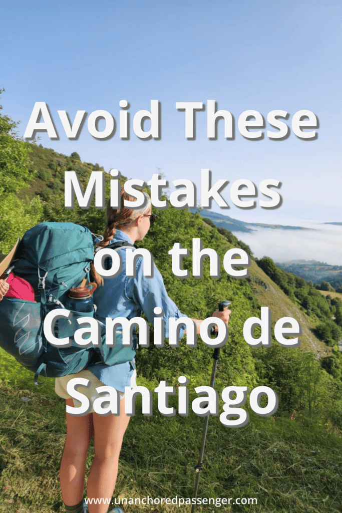 Hiker looking out at a green valley below with tact that says, "Avoid These Mistakes on the Camino de Santiago"