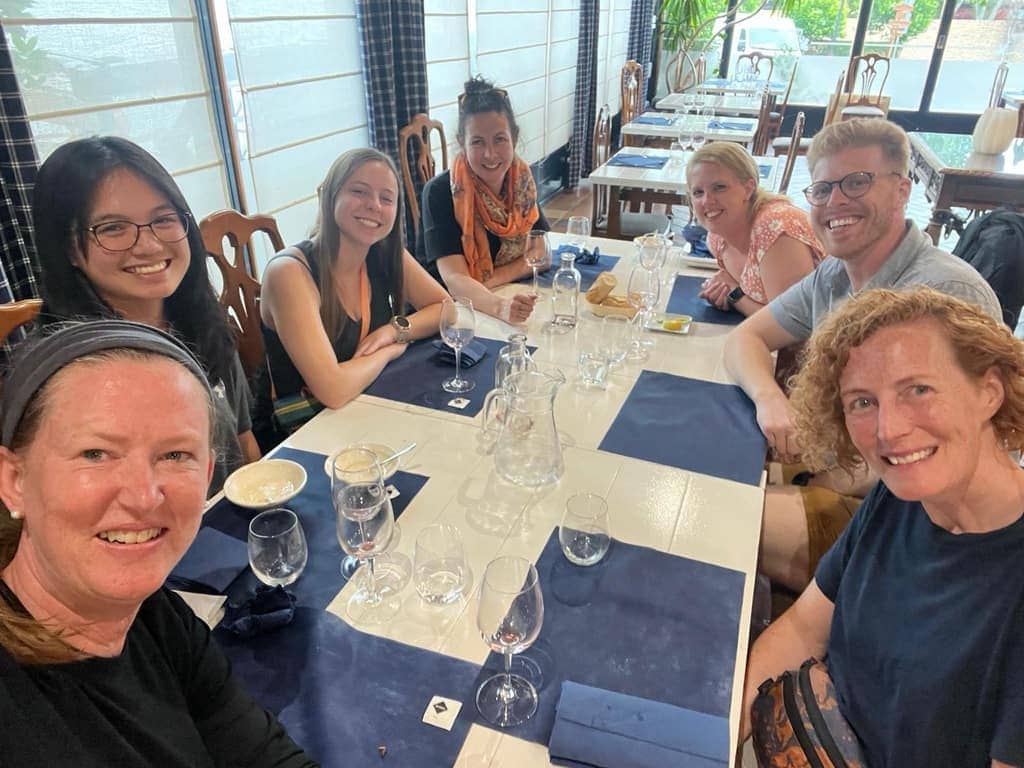 Group of pilgrims eating dinner together at an albergue in Puente La Reina along the Camino Frances