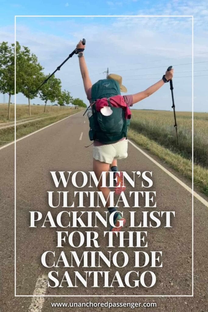 Hiker on an open road jumping up in the air with hiking poles and hands up and text that reads, "Women's Ultimate Packing List for the Camino de Santiago"