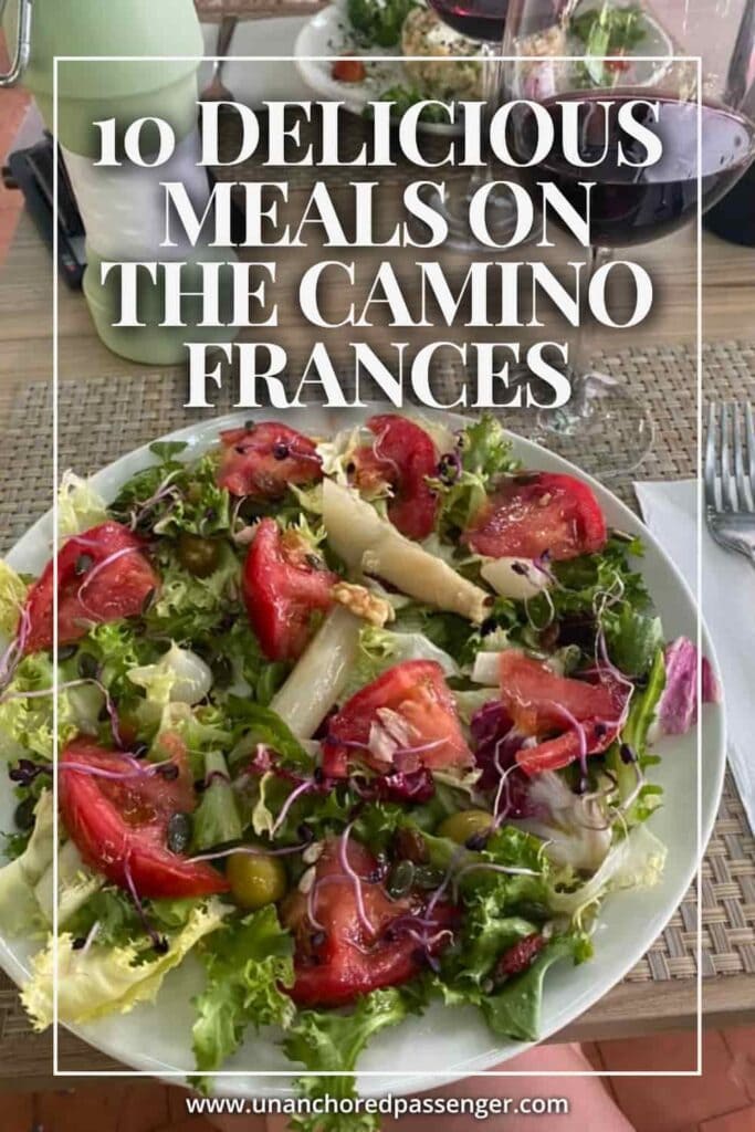 Large salad with lettuce, tomatoes and white asparagus and text that says, "10 Delicious Meals on the Camino Francés"