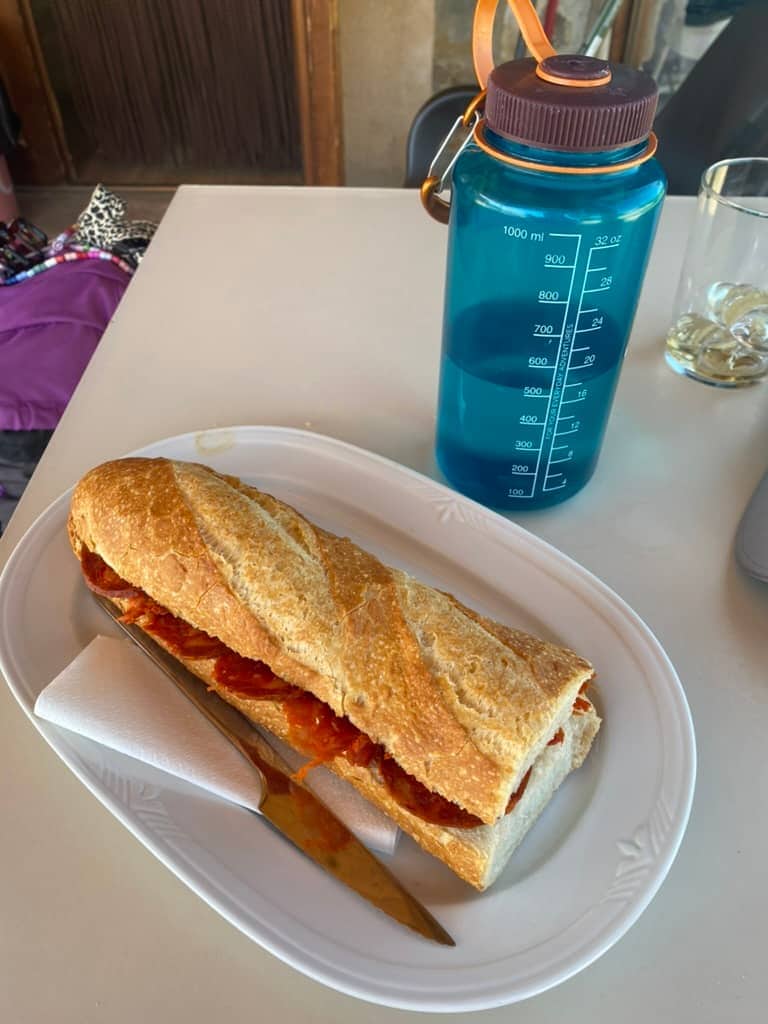 Nalgene water bottle next to a sandwich along the Camino de Santiago