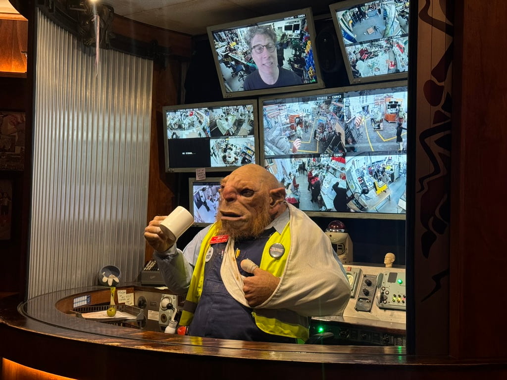 Animatronic orc-looking creature dressed as a security guard. They call this guy Jeff and say he's the Wētā Workshop Unleashed security guard in Auckland.