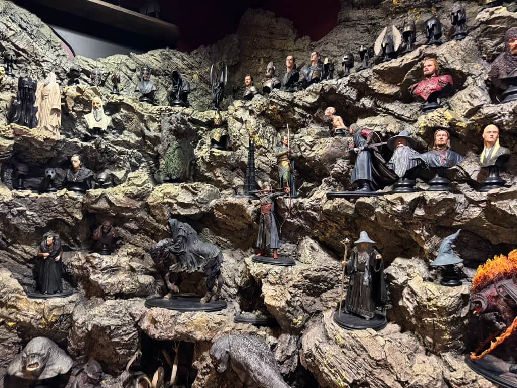 Shelves full of dozens of miniature statues of characters from The Lord of the Rings at the mini-museum at Wētā Workshop Wellington.