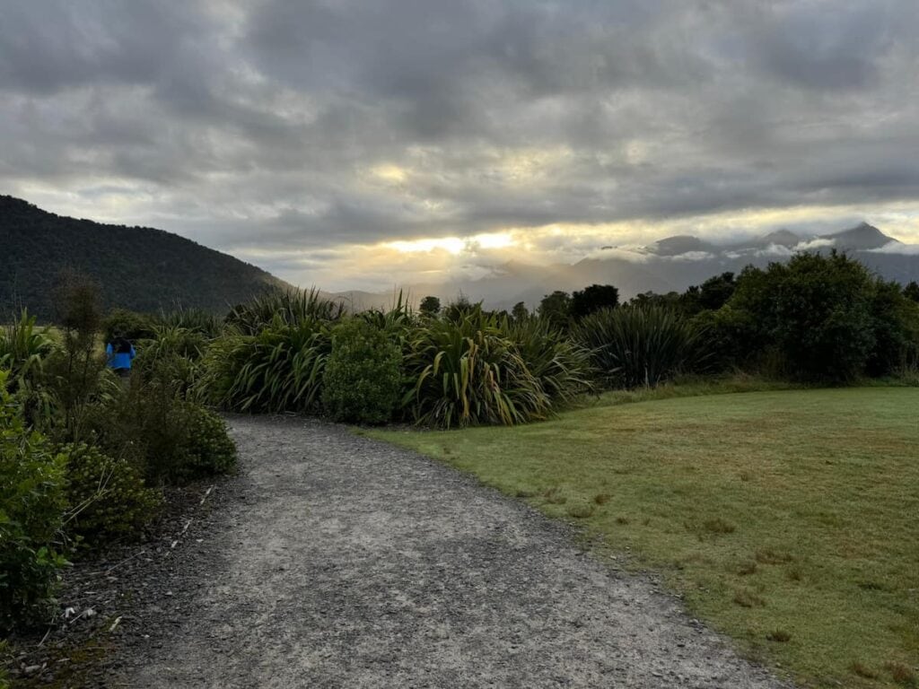 Cloudy sunrise from the Lake Matheson area in Fox Glacier with the mountains hidden in the clouds.