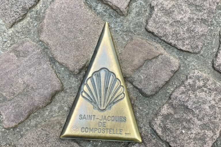 Camino de Santiago shell marker in the cobblestone street at the Porte de Saint-Jacques in Saint-Jean-Pied-de-Port.
