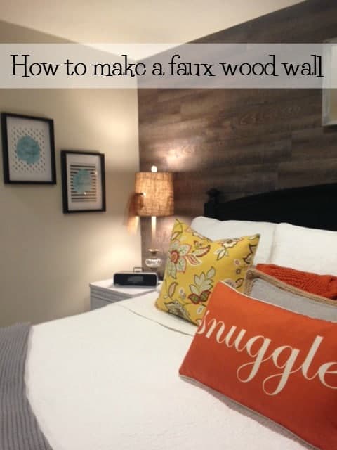 bedroom with a faux wood wall behind the bed