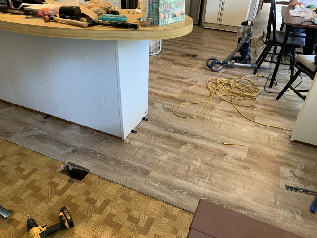 mobile home remodel before and after.  The new flooring in progress.