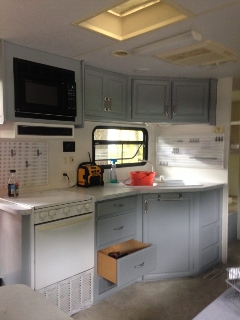 picture of our RV kitchen after painting the cabinets and walls. Camper remodel before and after