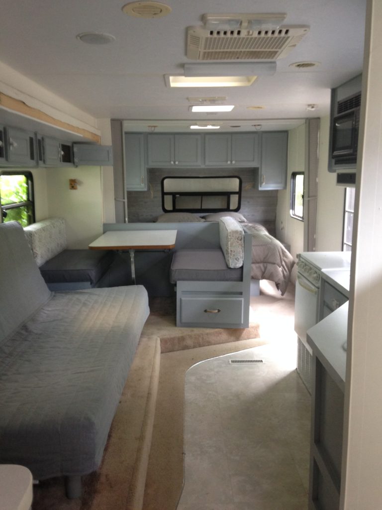 picture of our RV after painting the cabinets and walls. Camper remodel before and after