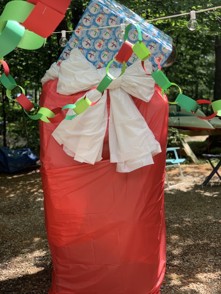 large santa bag made from plastic frame and red plastic tablecloths