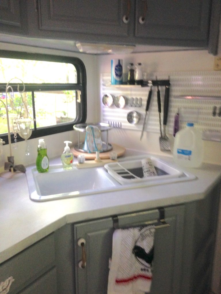 picture of our RV kitchen after painting walls and cabinets. Camper remodel before and after