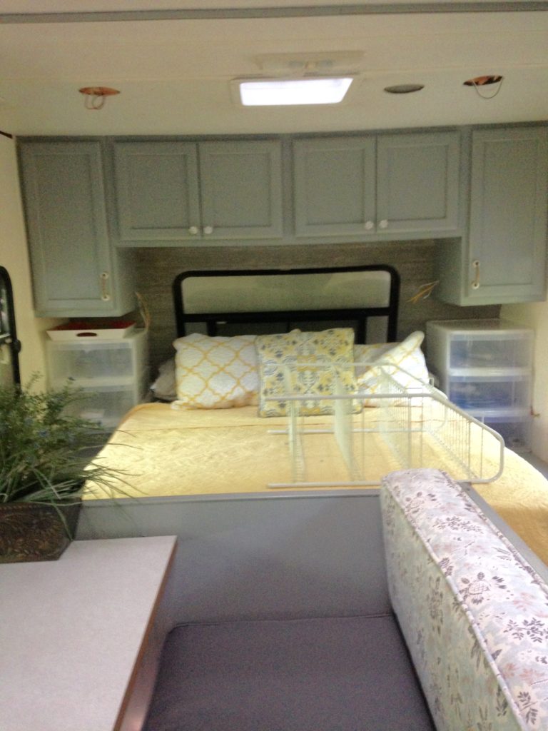 picture of our RV bedroom after painting the cabinets and walls. Camper remodel before and after