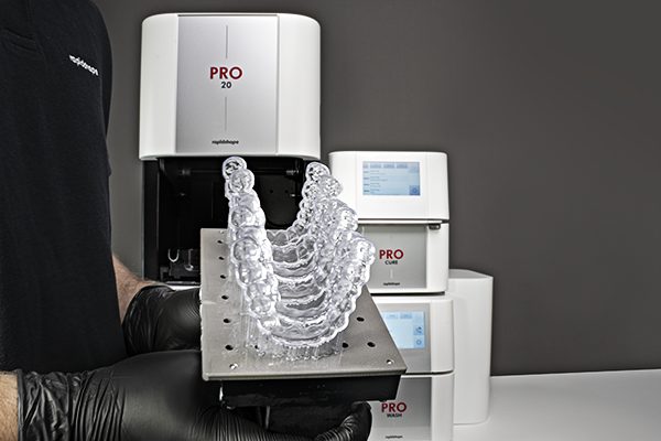 Six clear dental splints printed on the PRO 20’s build platform using RS Crystal Polish