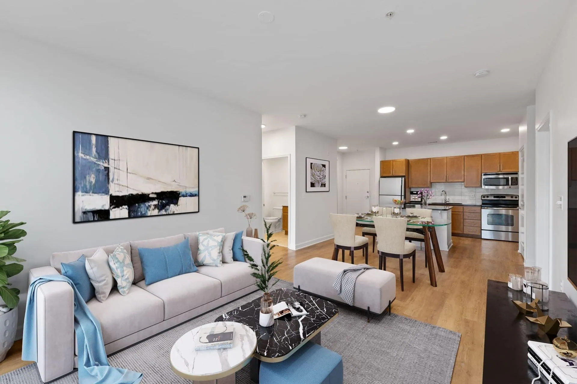 a living room with a couch and a table and a kitchen