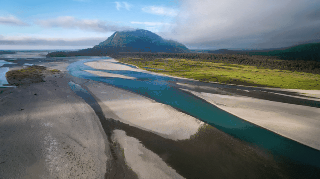An aerial view of a river and mountains.
