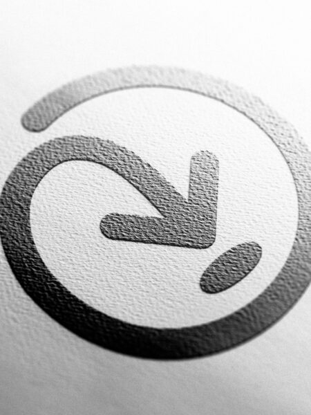 A black and white Addressfinder icon with an arrow on it.
